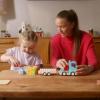 Picture of Casey Stoney playing with duplo with a young child for the celebrate like a pro campaign