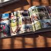photobook open on a table to reveal a page full of photos