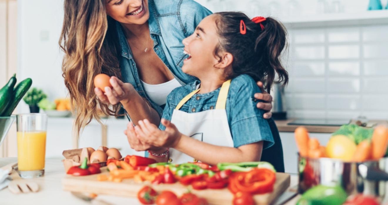picture of a happy mum and child preparing a healthy nutritious meal together