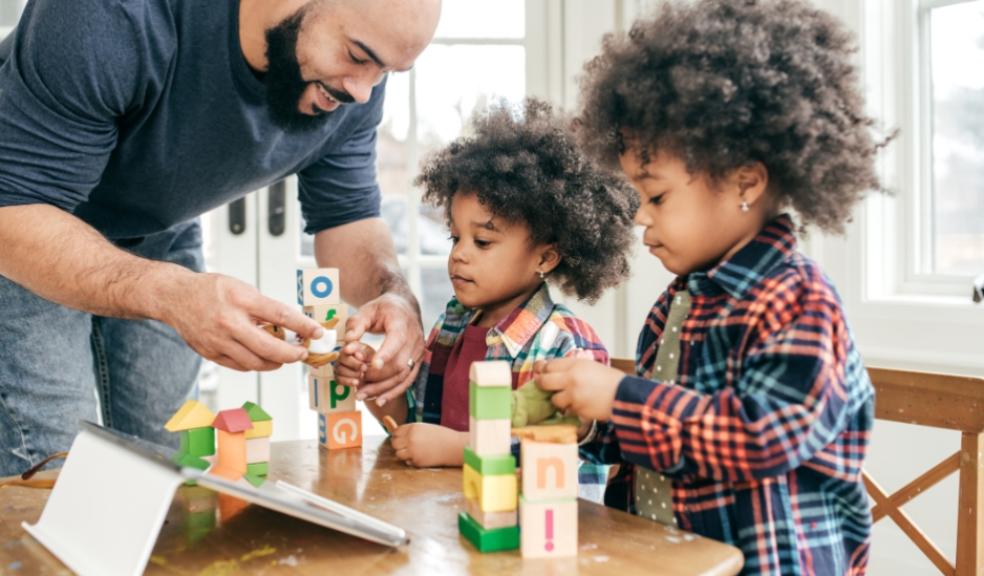 a dad helping his children build some towers out of blocks picture of a dad helping his children build some towers out of blocks