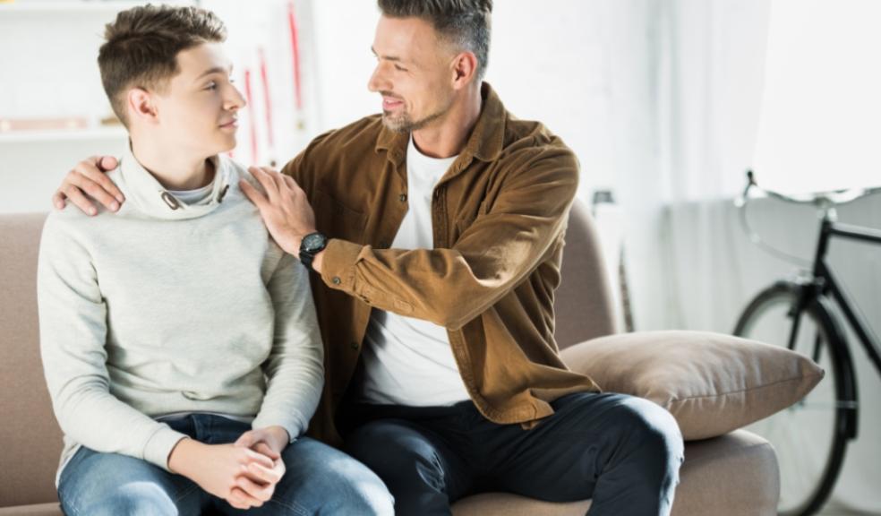 a dad with his arms around his teenage son supporting him through mental health picture of a dad with his arms around his teenage son supporting him through mental health