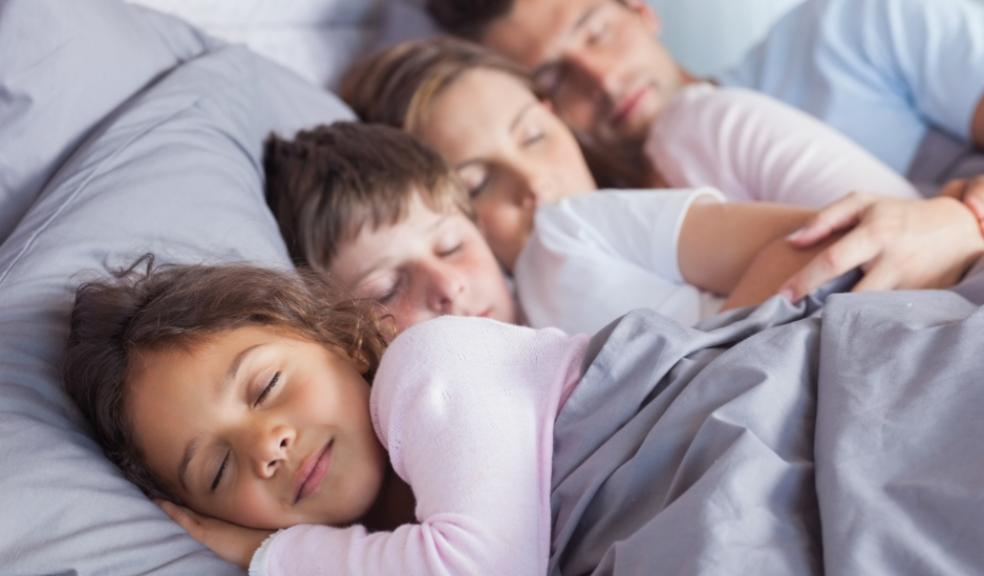 a family in bed together asleep picture of a family in bed together asleep