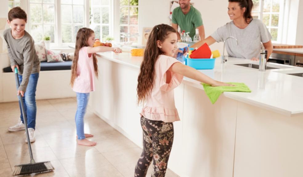 picture of a happy family cleaning the kitchen together