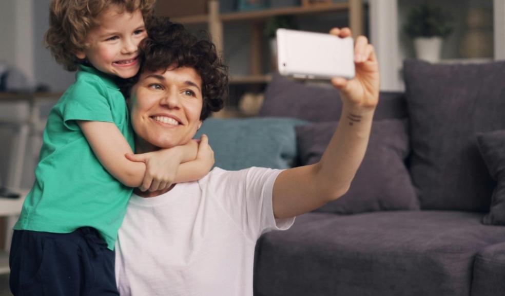 a mum taking a selfie photograph of her and her son on her smartphone picture of a mum taking a selfie photograph of her and her son on her smartphone