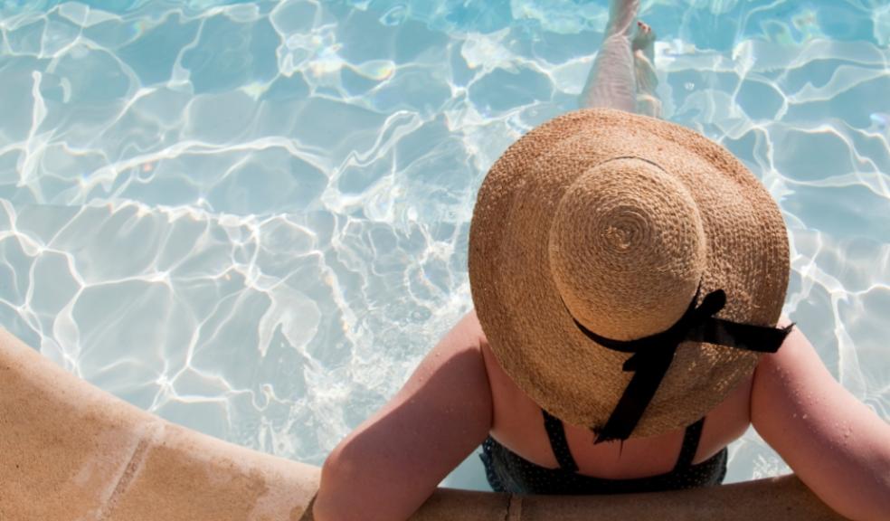a woman sitting in a pool on holiday whilst solo travelling picture of a woman sitting in a pool on holiday whilst solo travelling