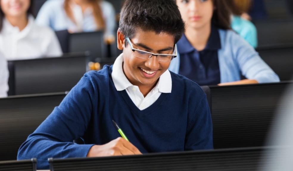 happy children sat in a classroom at a private school picture of happy children sat in a classroom at a private school