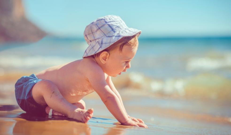 a baby on a beach on a sunny day picture of a baby on a beach on a sunny day