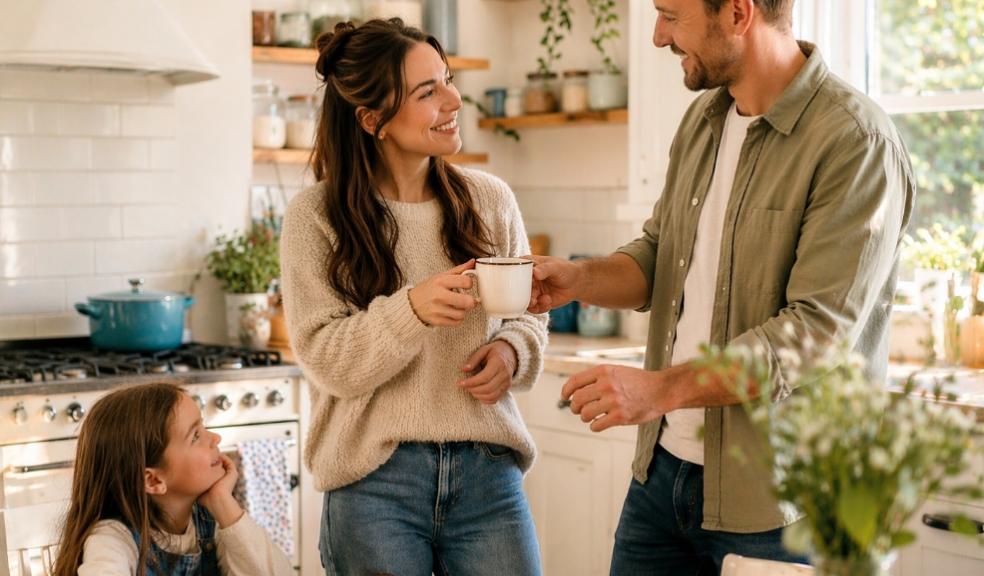 picture of Couple sharing a cup of tea in a bright family kitchen while child watches, showing everyday love and kindness at home