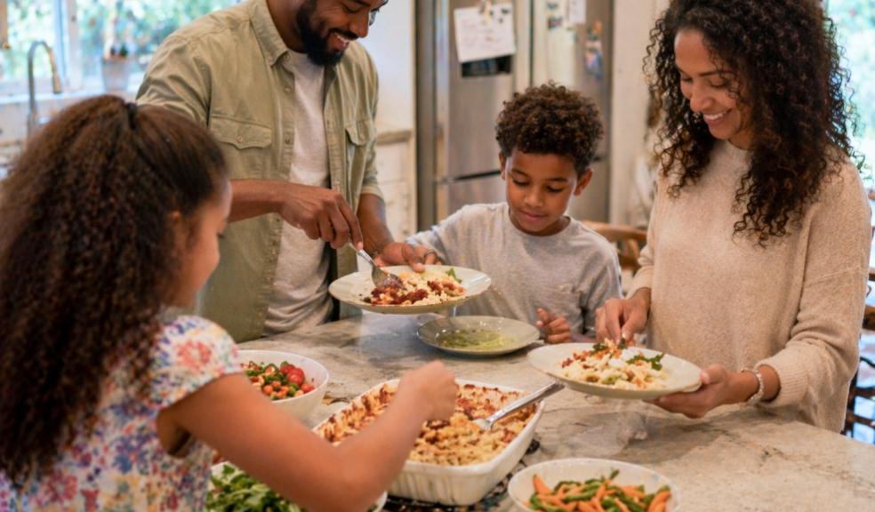 Family eating together at home showing the importance of shared mealtimes and family picture of Family eating together at home showing the importance of shared mealtimes and family