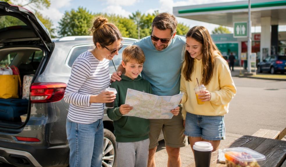 a happy family planning a road trip at a UK service station picture of a happy family planning a road trip at a UK service station