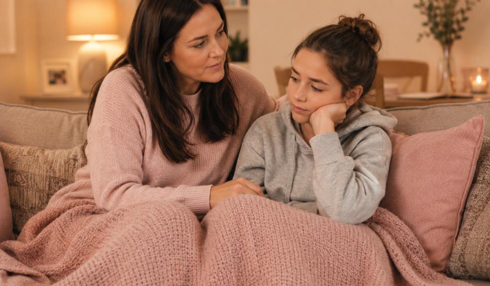 picture of a mum and daughter cuddled on the sofa under a blanket navigating changing hormones