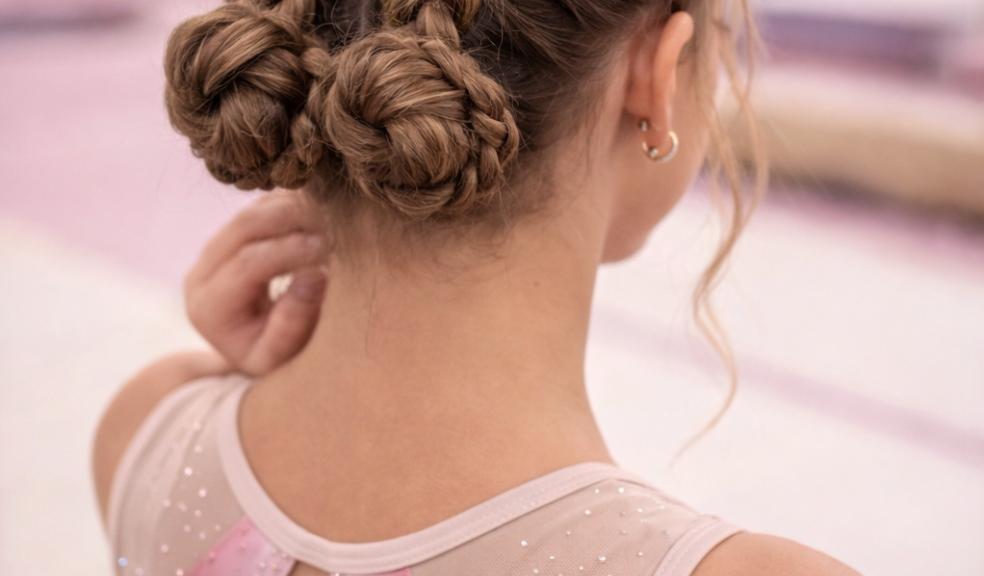 picture of a tween gymnastic with dutch hair braids into a bun for gymnastic competition hair