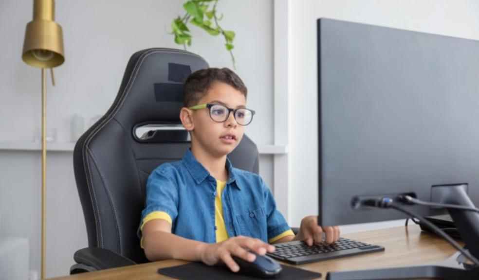 Child wearing glasses using a computer picture of a Child wearing glasses using a computer