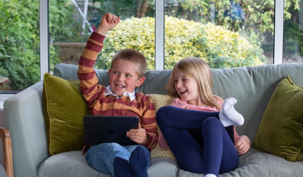 two happy children using the doodle maths app on devices picture of two happy children using the doodle maths app on devices