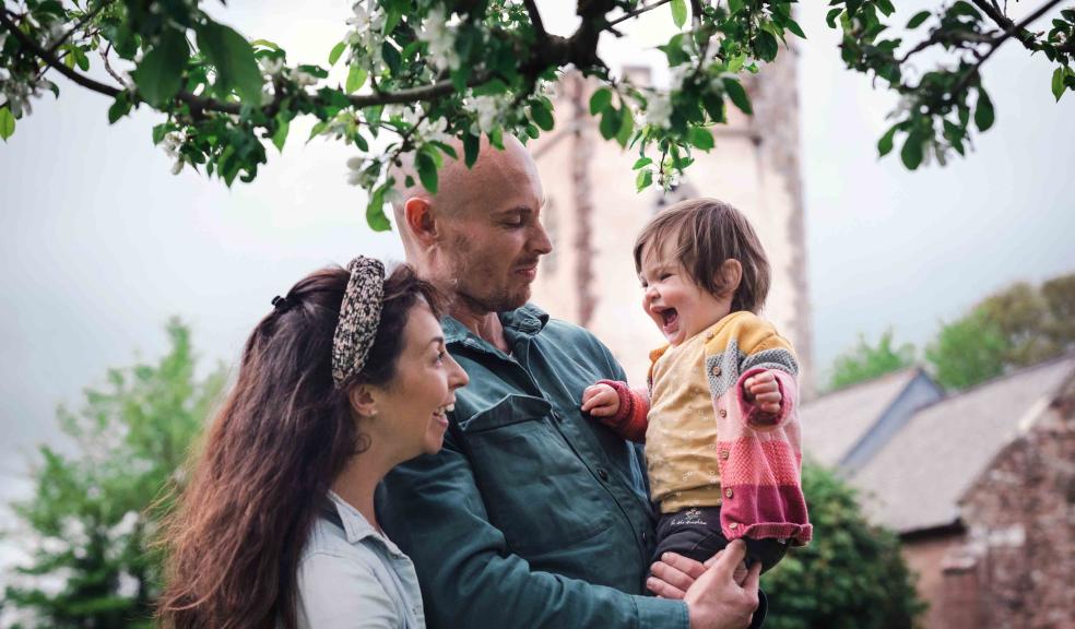 taking natural picture captures personalities and connections in a way a posed image rarely can dad holds giggling little girl while mum pulls faces