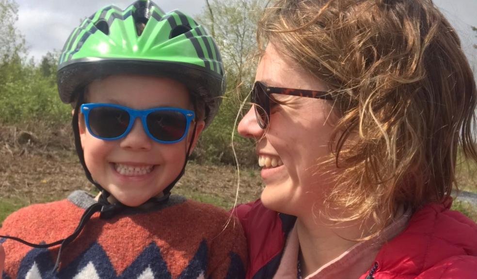 Image of woman holding her nephew wearing a cycling helmet Image of woman holding her nephew wearing a cycling helmet