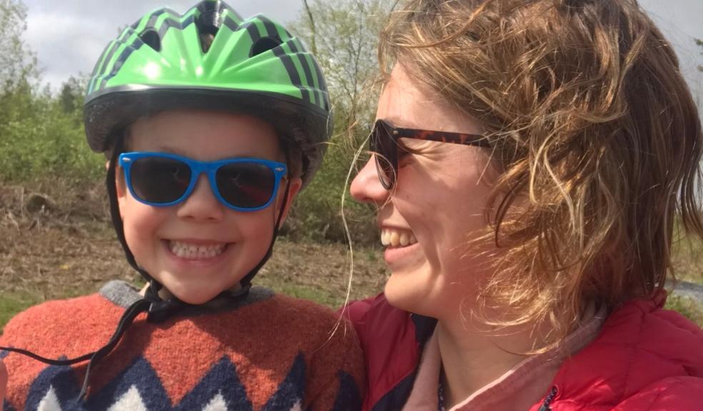 Image of woman holding her nephew wearing a cycling helmet