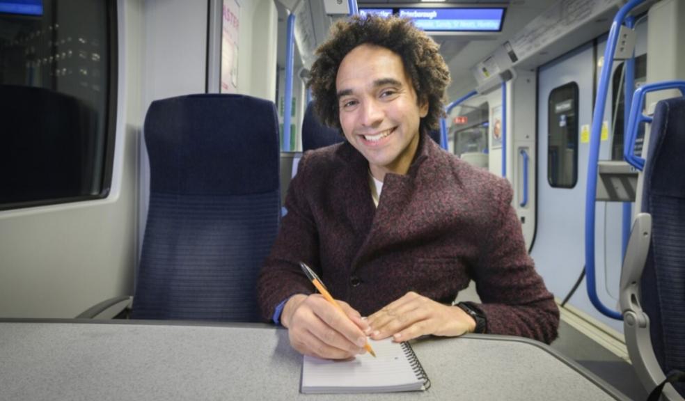 picture of Joseph Coelho writing a poem on a train