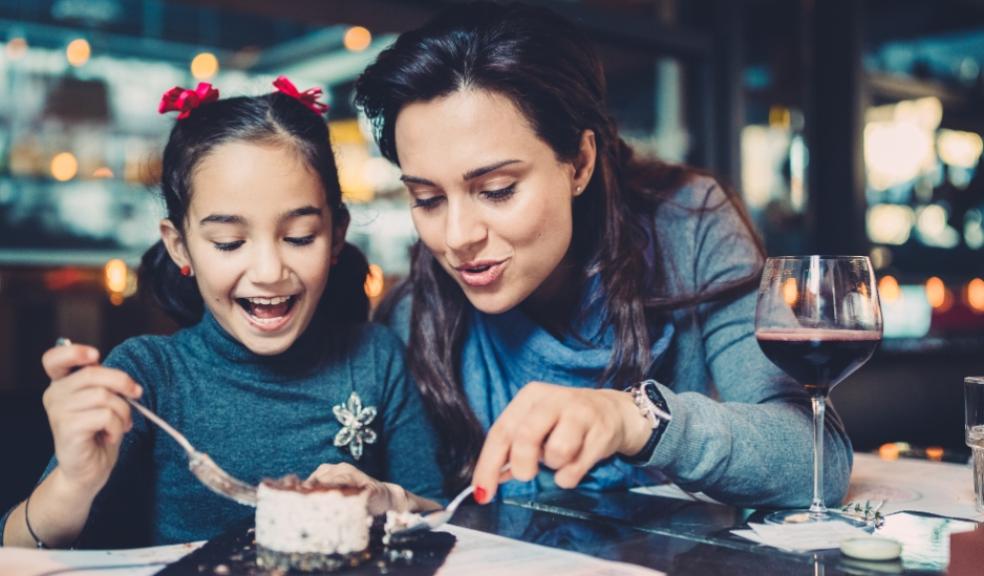 picture of a Mother and daughter eating in a restaurant