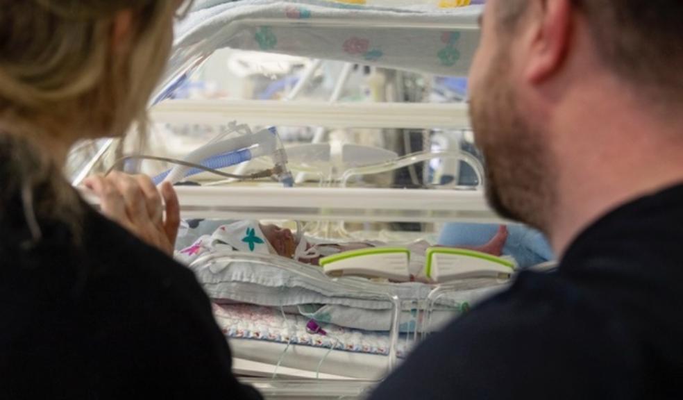 Mum and dad with baby in neonatal unit