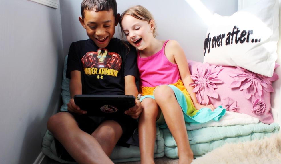 Picture from Natterhub of a boy and girl playing on an electronic device
