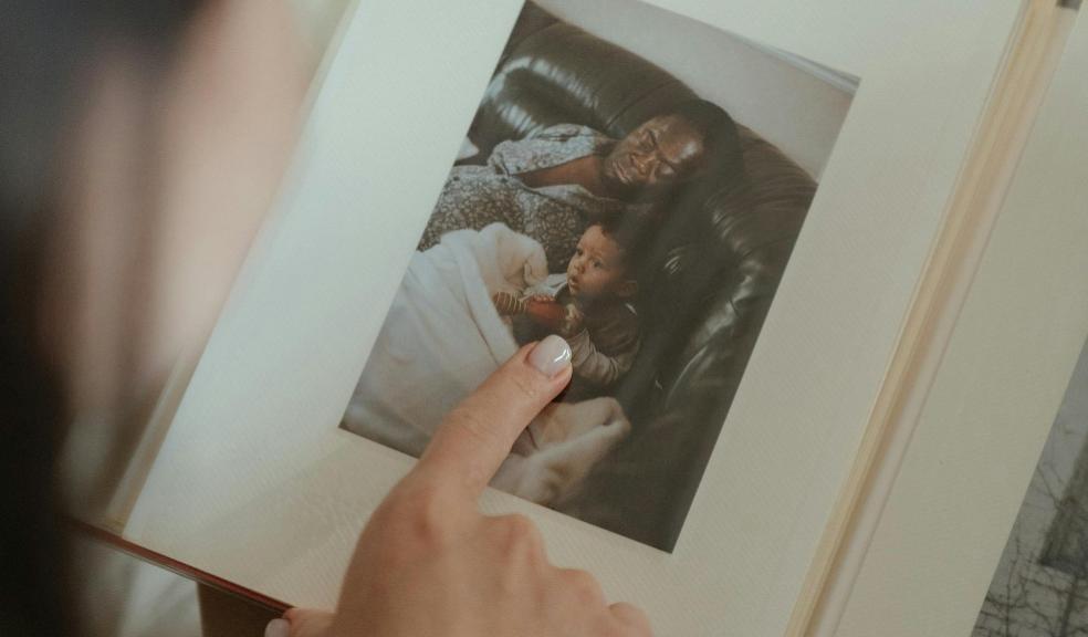 people looking at a baby photo album picture of a baby photo album