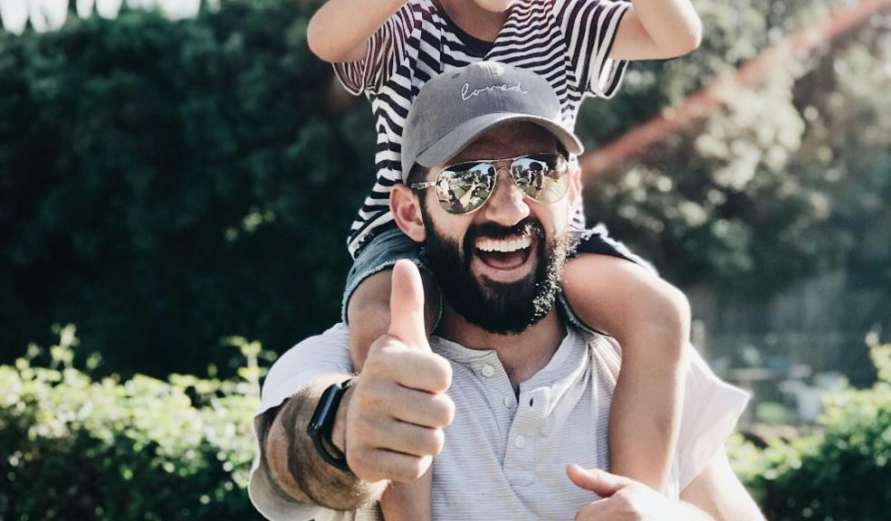 a happy dad with his child on his shoulders picture of a a happy dad with his child on his shoulders