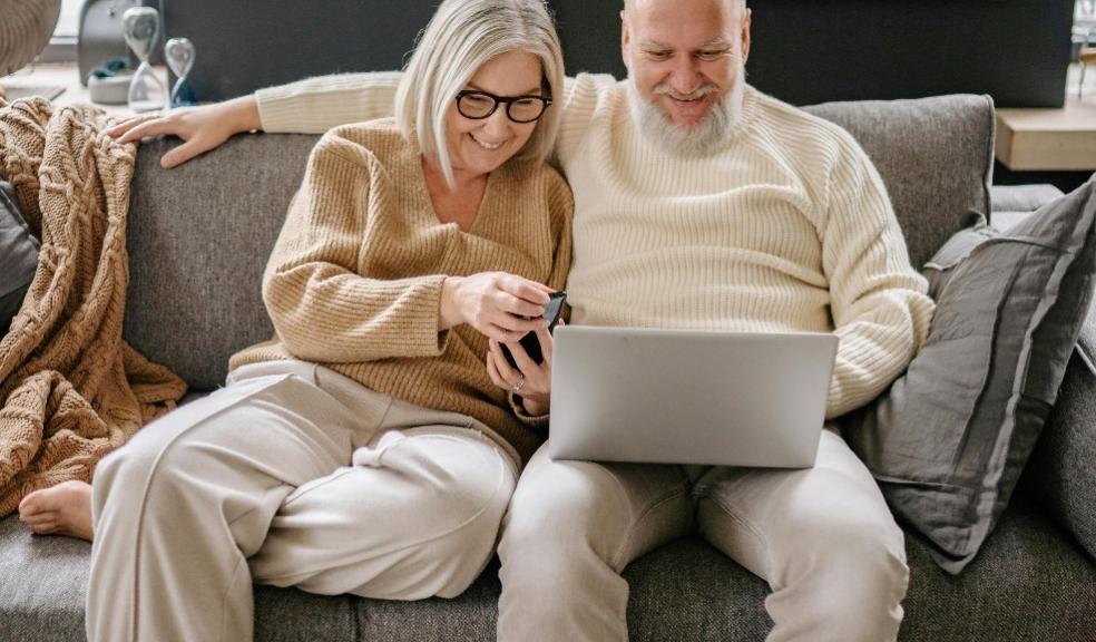 picture of a happy retired couple looking at a laptop