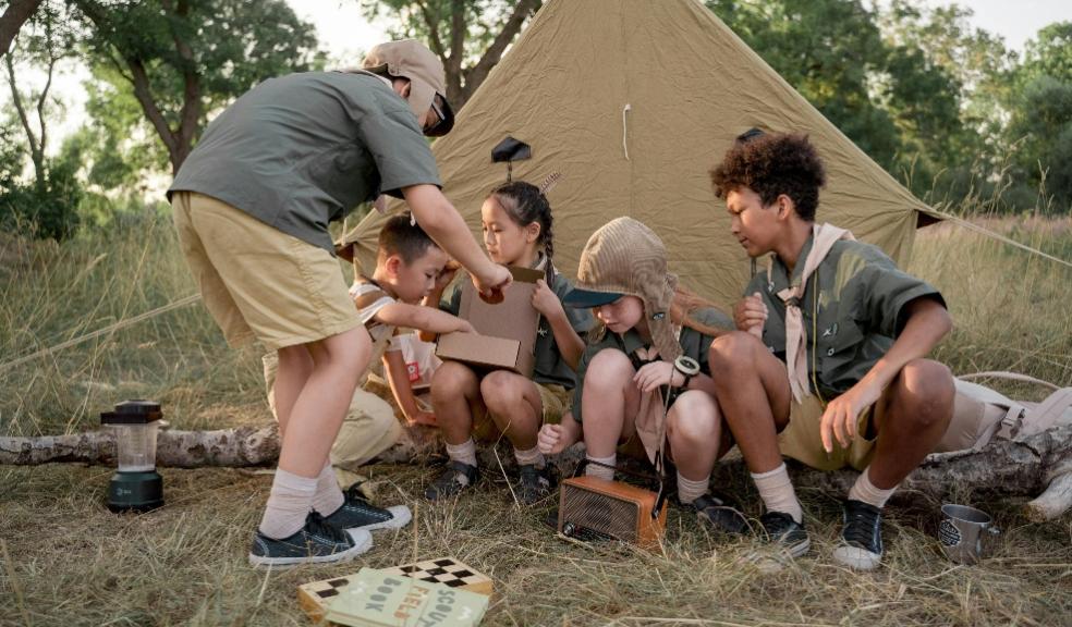 picture of children doing outdoor activities next to a tent