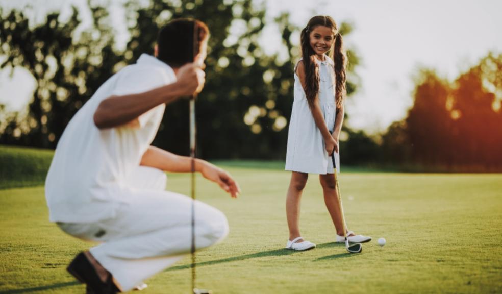 Picture of a father and daughter playing golf