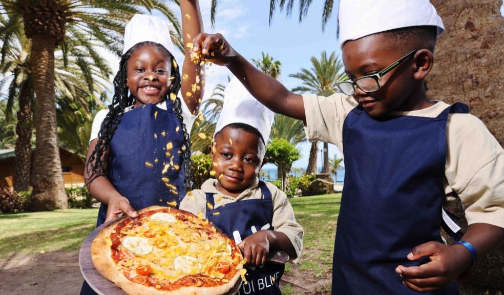 picture of children putting cornflakes on a pizza
