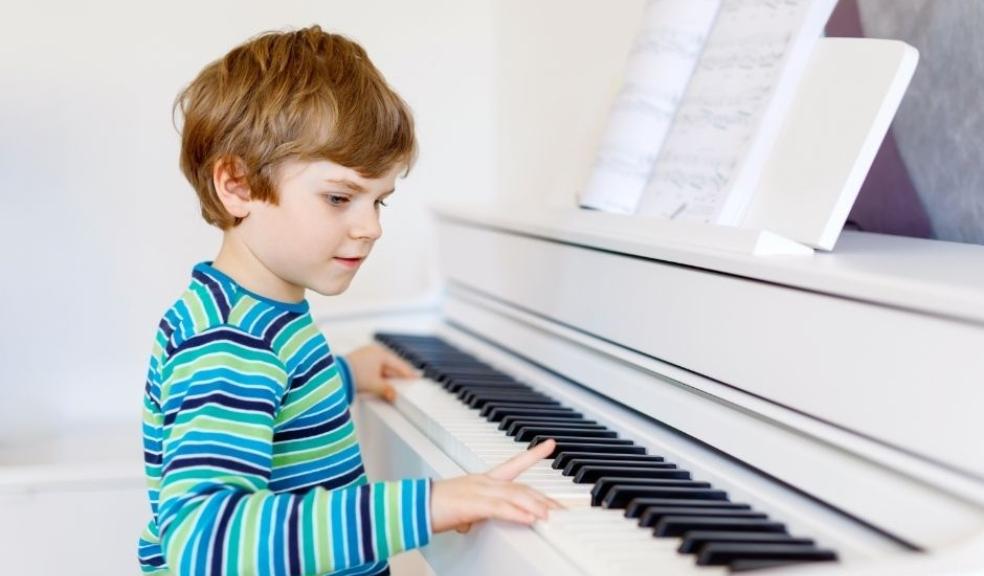 Picture of a healthy young boy playing the piano