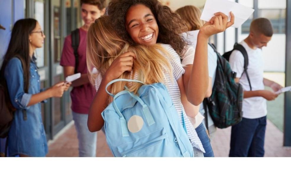 Picture of girls celebrating exam results in school corridor 