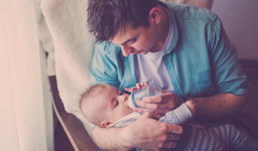 Picture of a single dad feeding his baby son