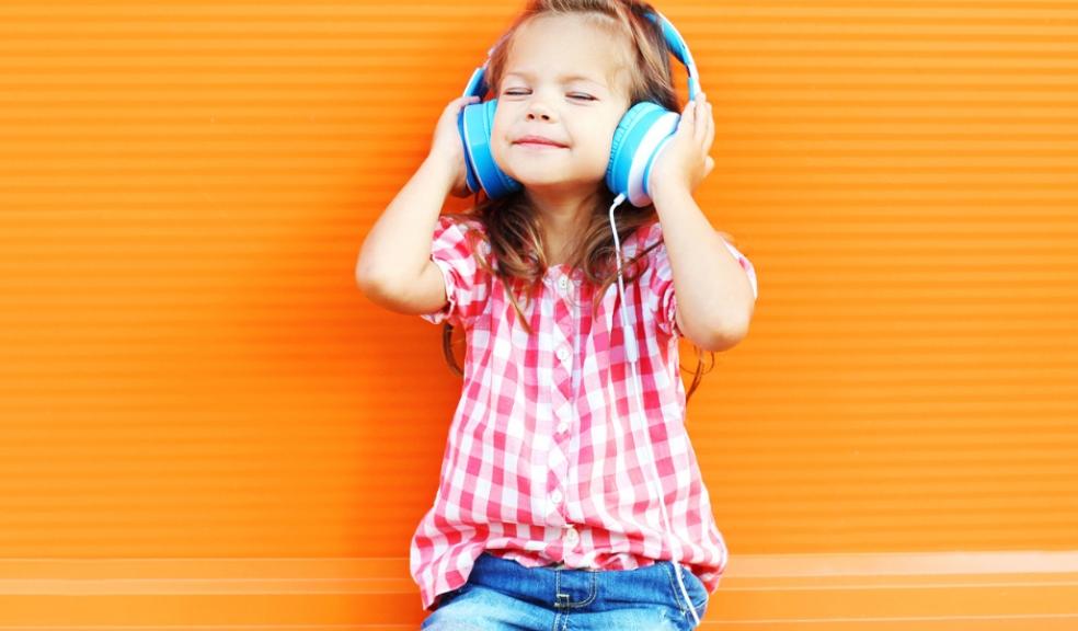 Picture of a happy child listening to headphones
