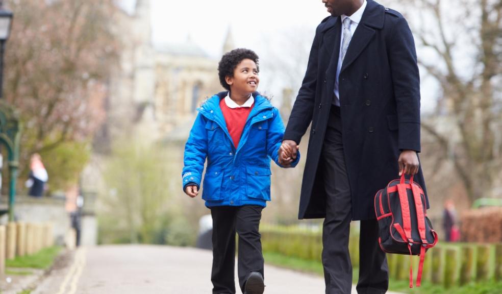 Picture of a father walking his son to school
