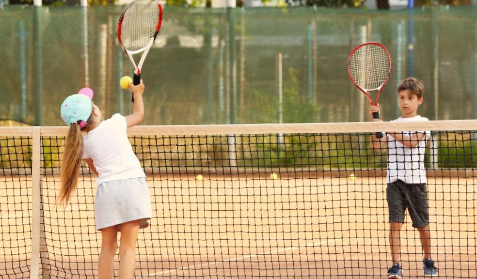 Picture of children playing tennis on a tennis court