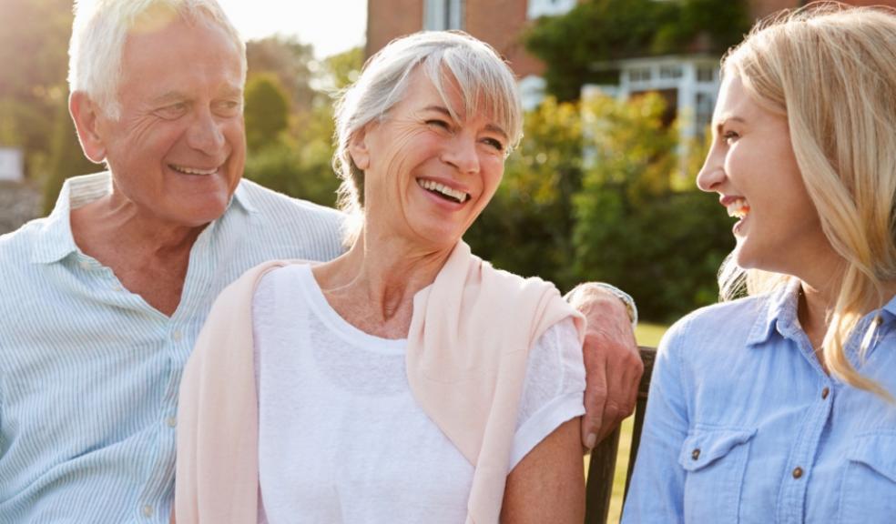 Picture of adult child at home with her elderly parents