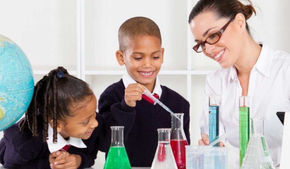 Picture of a science teacher doing experiments with primary school children