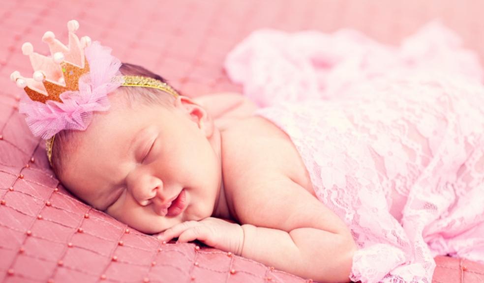 picture of newborn baby girl in pink wearing a crown