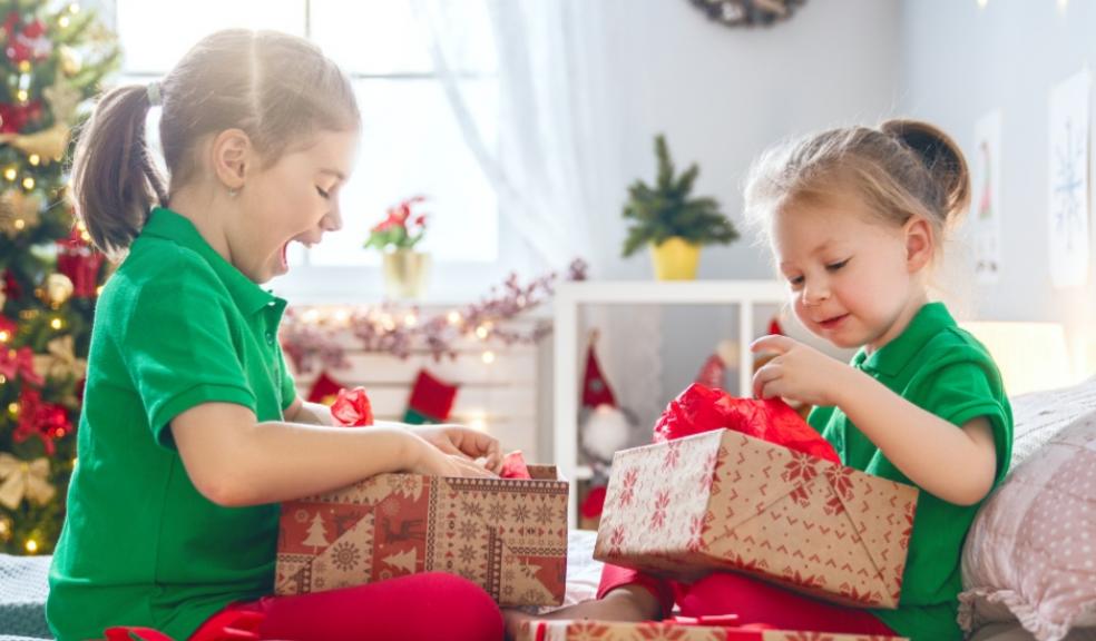 picture of excited children opening their christmas presents