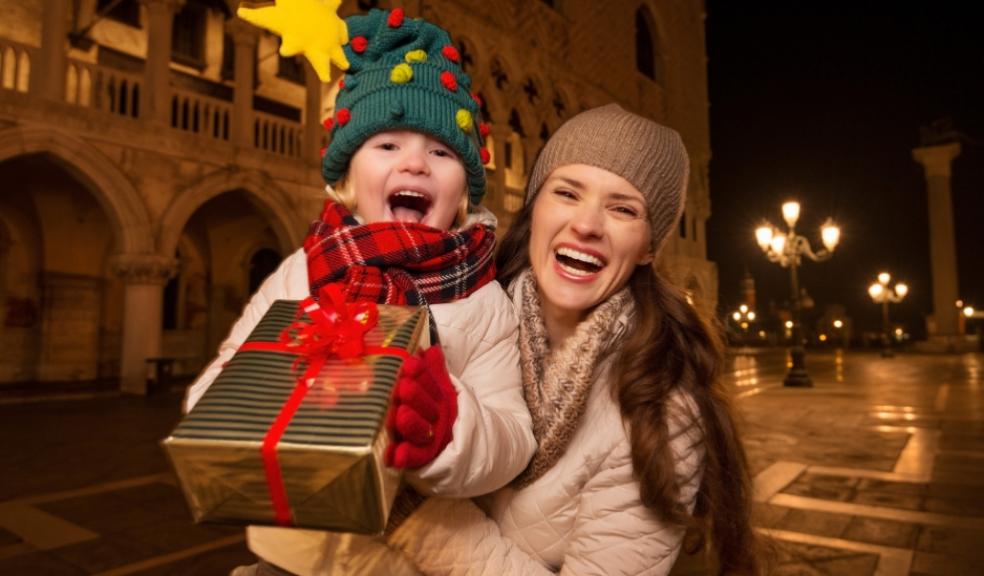 picture of a mum and child holding a present at a christmas experience