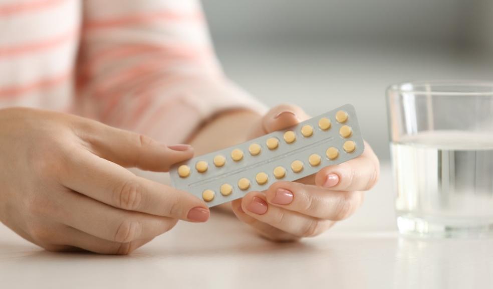 picture of woman holding a packet of contraceptive pills