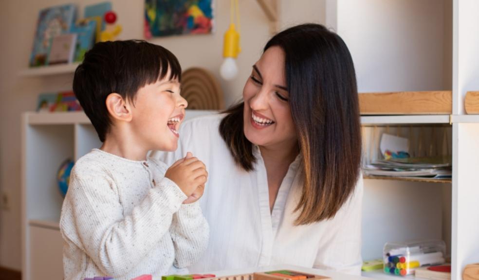 picture of a teacher teaching a happy child