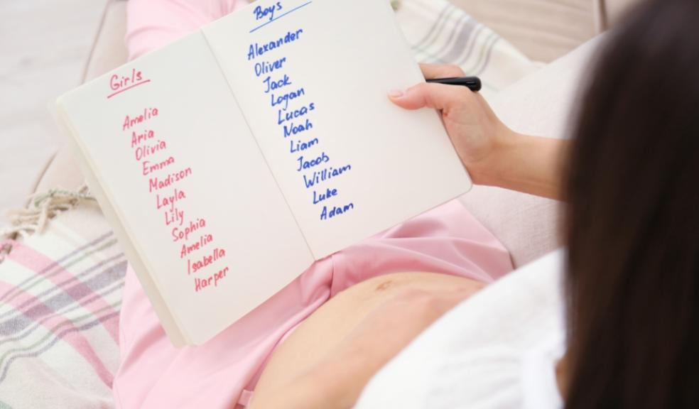 picture of a pregnant woman writing a list of baby names