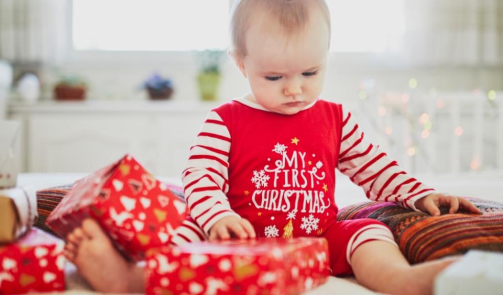 picture of a baby at christmas wearing a my first christmas outfit