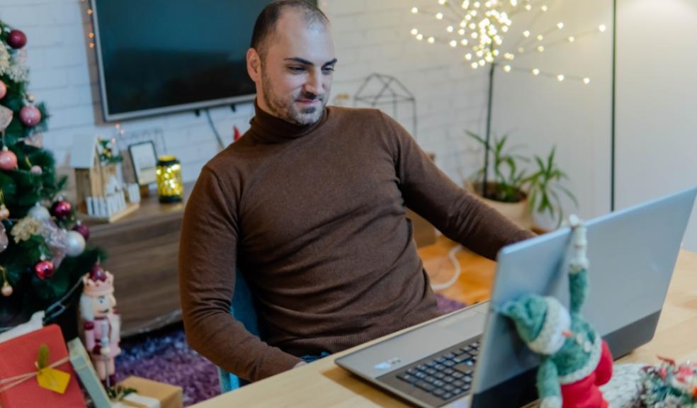 picture of a man in his home looking at a laptop