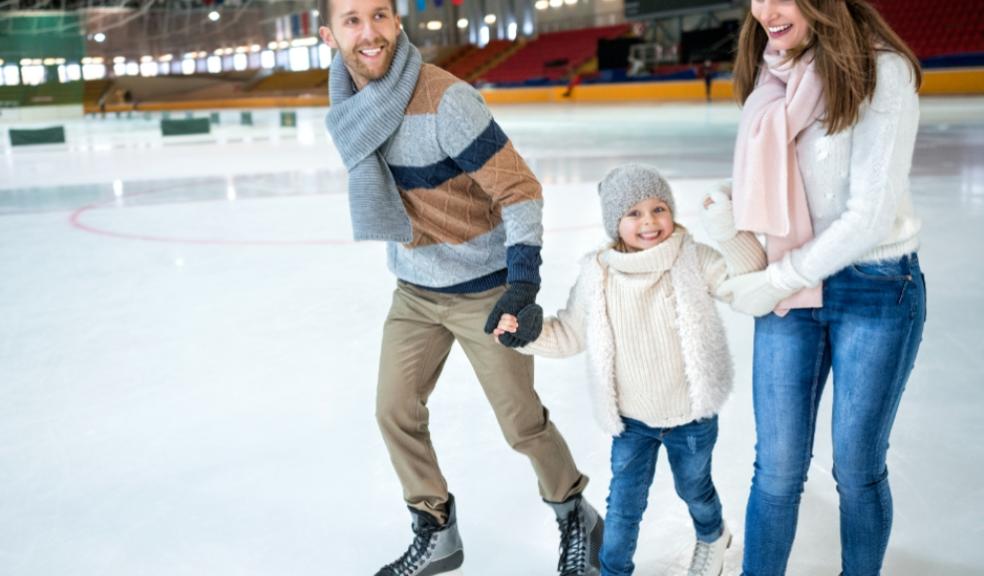 picture of a happy family at an ice skating rink
