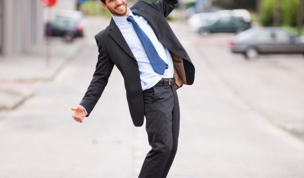 picture of a middle aged man in a suit skateboarding