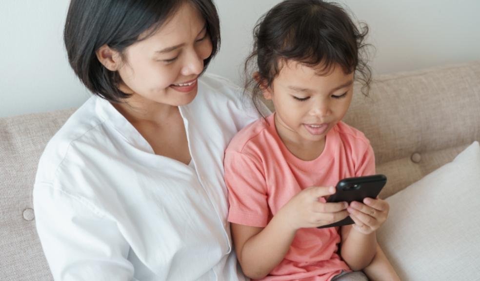picture of a happy mum and her child using a smartphone